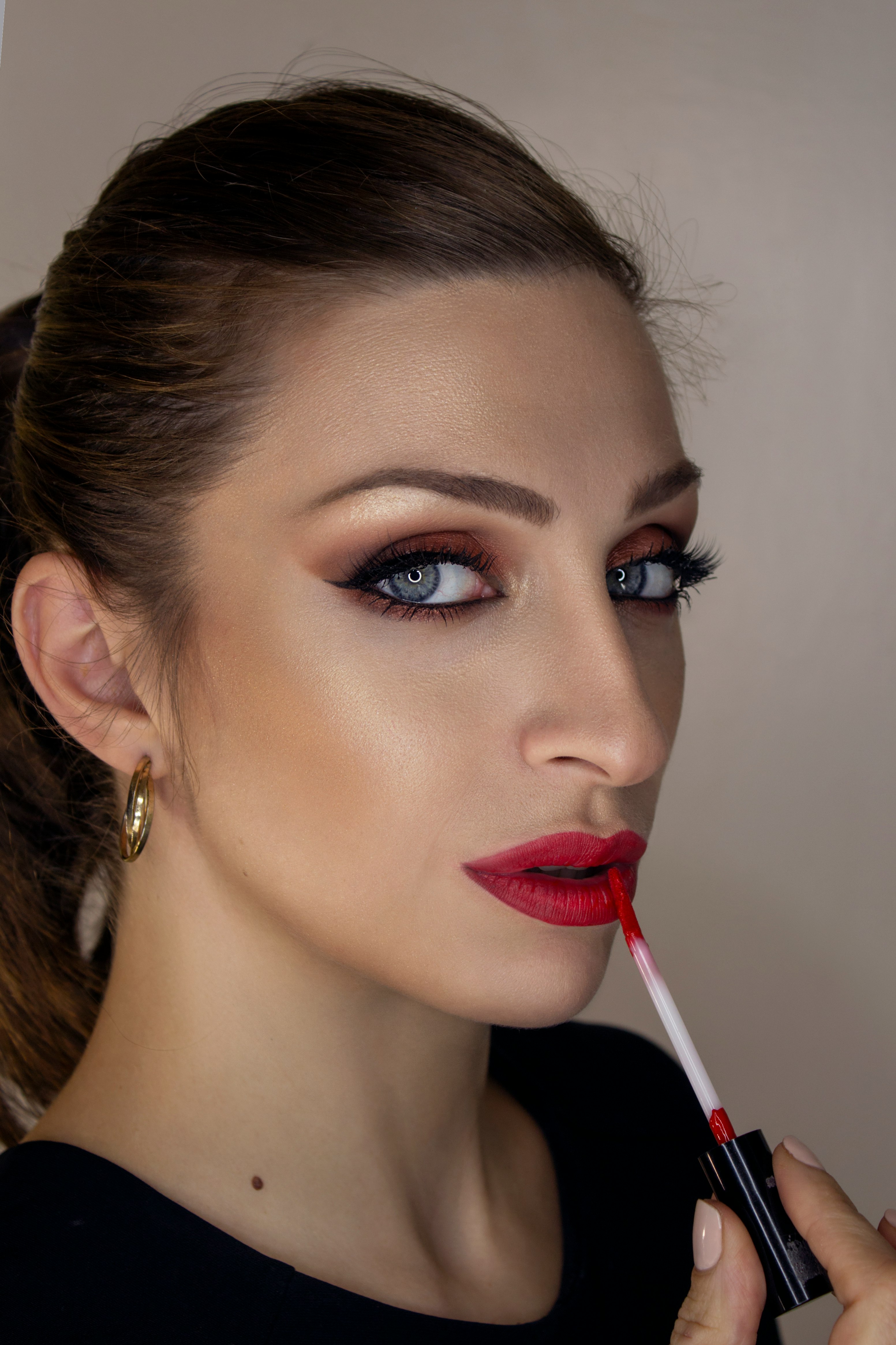 woman with red lipstick and black mascara